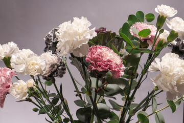 Beautiful bouquet of pink, grey and white carnation flowers, fresh eucalyptusas and violet brassica flower.