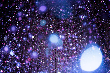 Celebration lights at Christmas New Year festival. Crowd of hanging blue light bulbs blue bokeh background. blue light bulb tunnel. 