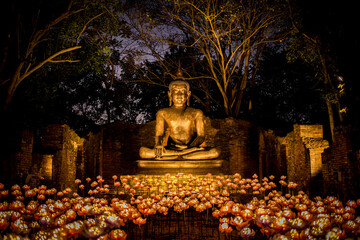 Buddha statue in the garden surrounded by beautiful lights at night. Ancient, Architecture, Art, Asia, Beauty