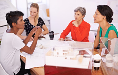 Group of people, architect or business in meeting, teamwork or planning of creative brainstorm. Businesswomen, blueprint or model as corporate, diversity or collaboration in property development