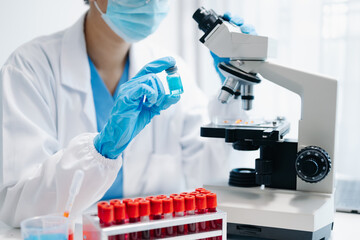 Female scientist researcher conducting an experiment working in the laboratory