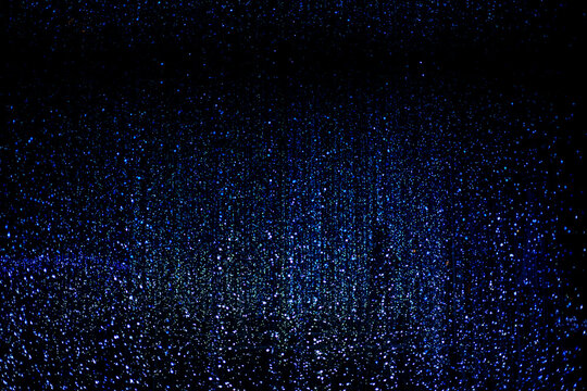 Celebration lights at Christmas New Year festival. Crowd of hanging blue light bulbs blue bokeh background. blue light bulb tunnel. 