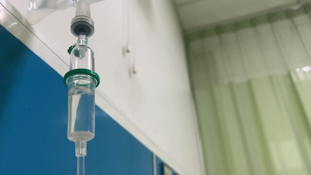 Closeup of IV drip in hospital, Intravenous saline solution, IV loading dose.