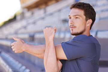 Fitness, arms and man stretching in stadium for race, marathon or competition training for health....