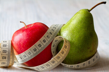 Apple and pear with tape measure, healthy diet, female figure types, concept