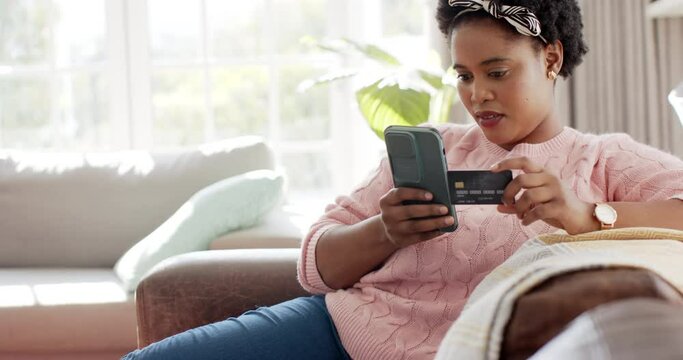 African American woman is shopping online with a credit card with copy space at home
