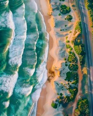 Aerial view capturing Australia's stunning beach, emerald waters, and scenic road, showcasing waves meeting the sandy shore in a beautiful natural display.
