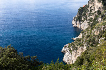 Fototapeta na wymiar Amalfi coast, view of the mountainous coast washed by the sea and caressed by the blue sky