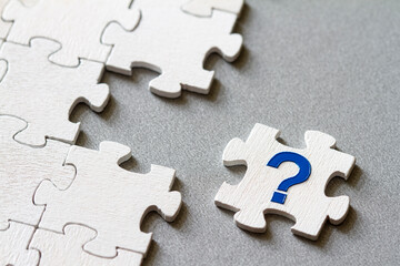 Puzzle piece with question mark, missing piece, business concept