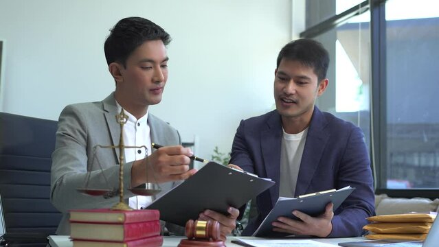 Business people and lawyers discussing contract papers sitting in the table at office, concepts of law, advice, legal services.