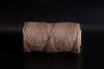 reel of hemp cord front view on black back ground