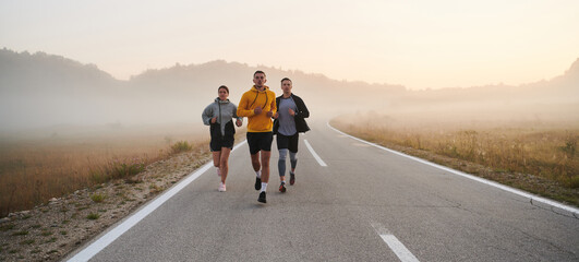Running towards a common goal, a group of colleagues braves the misty morning air, their...