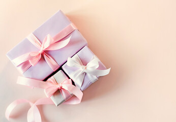 Soft color pink gift boxes decorated with ribbon top view. Holiday beautiful presents empty copy space. Mother's day. Women's day.