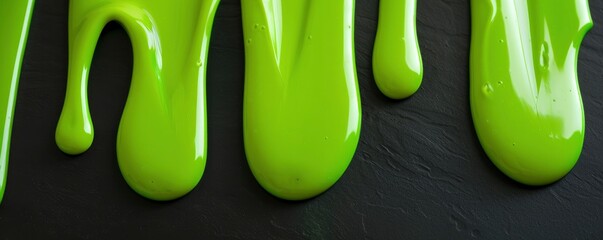 Viscous Green Fluid. Flowing Vertically in Smooth, Wavy Drips on a Black Surface - obrazy, fototapety, plakaty