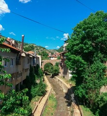Fototapeta na wymiar Stone Bridge in the Town of Kratovo, Macedonia. Landscape of the rustic village of Kratovo.