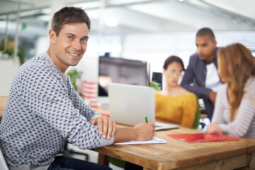 Portrait, smile and business man writing in office, startup or meeting for creative job in...
