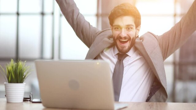 celebrating goal achievement winning online getting good news in email raising hands feeling euphoric.