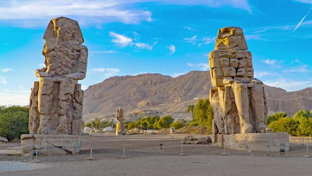 The Colossi of Memnon, two stone massive statues of the Pharaoh Amenhotep III, who reigned in Egypt during the Dynasty XVIII.