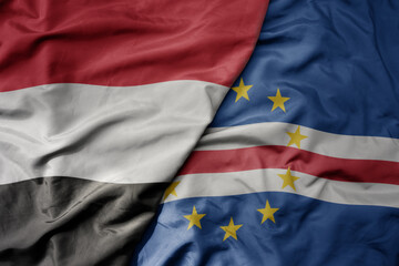 big waving national colorful flag of cape verde and national flag of yemen .