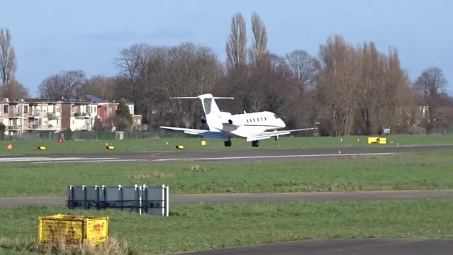 Business jet Landing with Touch Down at Airport (Corporate Executive Private Jet Touching down at Airfield)