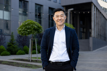 Confident businessman smiling outside modern office building