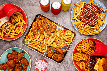 Deep fried food top view, set of the different dishes and drinks on the grey concrete background 