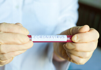 Hands holding blood test result for Coronavirus