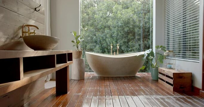 A modern bathroom features a freestanding bathtub and a wooden vanity with a vessel sink