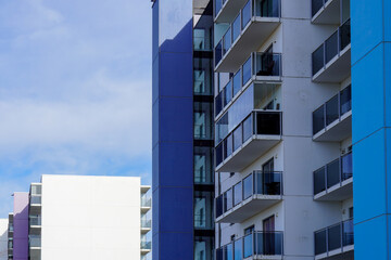 Looking up to the white apartments building with blue and navy blocks in Lasnamae district. Tallinn, Estonia, Europe. March 2024