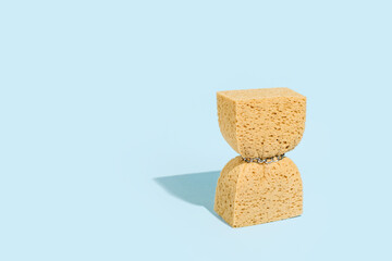 A washing sponge squeezed with a chain, minimal creative concept, body care, weight loss, obesity.