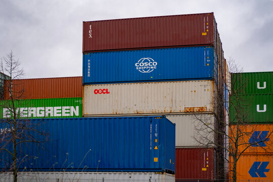 Shipping containers largest shipping and transportation companies stacked in port, COSCO, OOCL, Evergreen, Logistics and supply chain management, Frankfurt, Germany - January 21, 2024