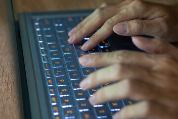 Close up image of hands typing on laptop computer keyboard and surfing the internet at home. Freelancer copywriter working project, typing text, edit something. Remote job concept