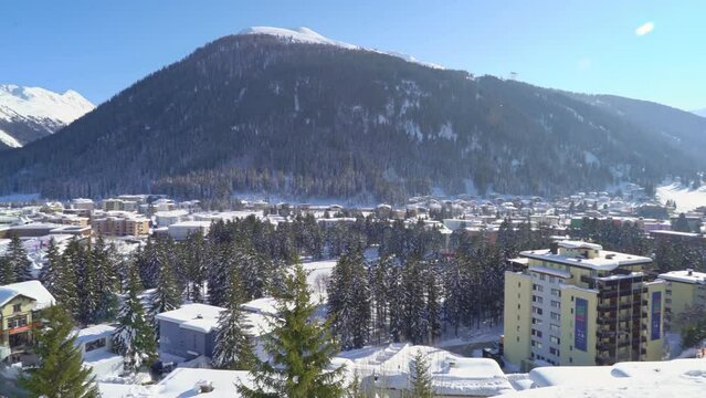 Davos in winter. Panoramic view of Davos in Switzerland. Preparations For The Davos World Economic Forum 2020. Snow-covered rooftops of town.