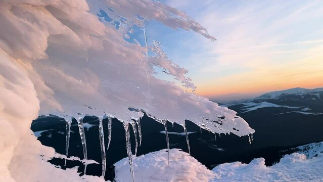sunset and sunrise on the Montenegrin ridge in the Carpathians, a colorful picturesque spectacle, golden and pink light on the ice, patterned by the wind