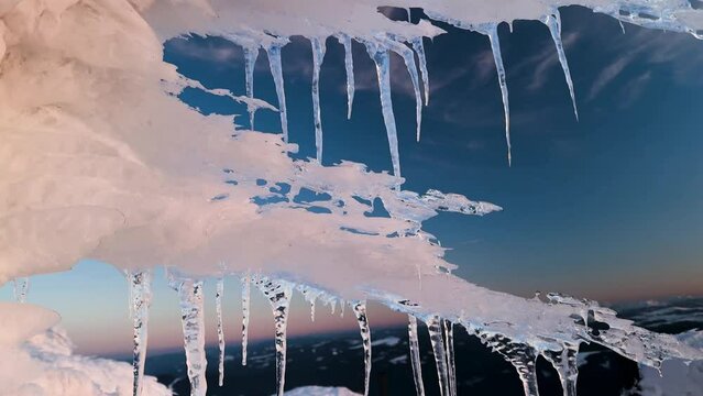 sunset and sunrise on the Montenegrin ridge in the Carpathians, a colorful picturesque spectacle, golden and pink light on the ice, patterned by the wind