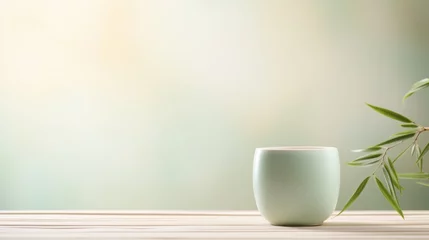 Deurstickers Product photo, delicate celadon porcelain teacup, soft colours, bamboo environment, minimalism, dreamy ethereal bokeh background  © paisorn