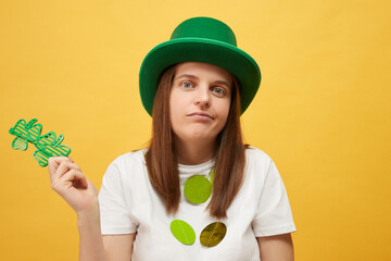 St. Patrick's day celebration Uncertain woman wearing green leprechaun hat and shamrock glasses...