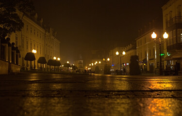 Street in the night with street lamps, after the rain