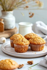 Obraz na płótnie Canvas Freshly baked vegan quinoa muffins served with milk on a light background