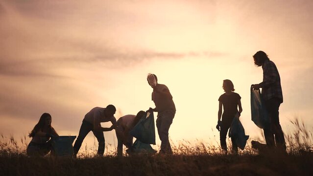 silhouette volunteers collect plastic. group team of people collect plastic bottles sunset together. environmental protection business concept. volunteers family collect plastic clean lifestyle nature