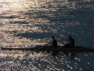 Rowing boat on river danube at sunset backlight - 757178216