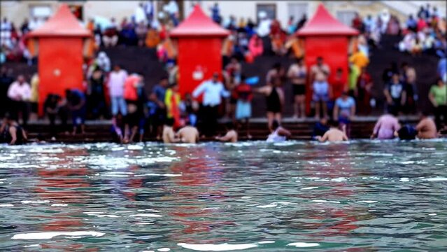 Crowd of people during mahashivratri taking bath in holy river Ganges at night in Haridwar, Uttarakhand, India.