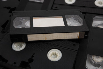 Videotape with blank tags. Pile of VHS video cassettes. Vintage media. Isolate on a white back