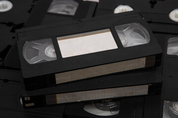 Videotape with blank tags. Pile of VHS video cassettes. Vintage media. Isolate on a white back - obrazy, fototapety, plakaty