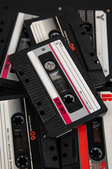 Close-up of many audio tapes. Analog storage medium. Cassettes for audio recordings and music....