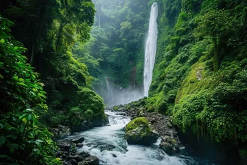 Muurstickers Bosrivier A powerful waterfall cascades amidst the vibrant green trees in a lush forest landscape, A river flowing into a waterfall in a rainforest, AI Generated