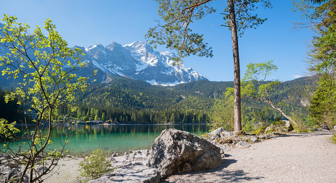walkway around lake Eibsee, stunning Zugspitze mountain, spring landscape upper bavaria