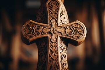 A close-up of a wooden Easter cross, with intricate patterns and symbols carved into it