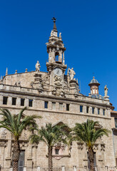 Fototapeta premium Palm trees in front of the Santos Juanes church in Valencia, Spain