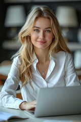Portrait of beautiful woman smiling while working with laptop in office. Businesswoman concept
